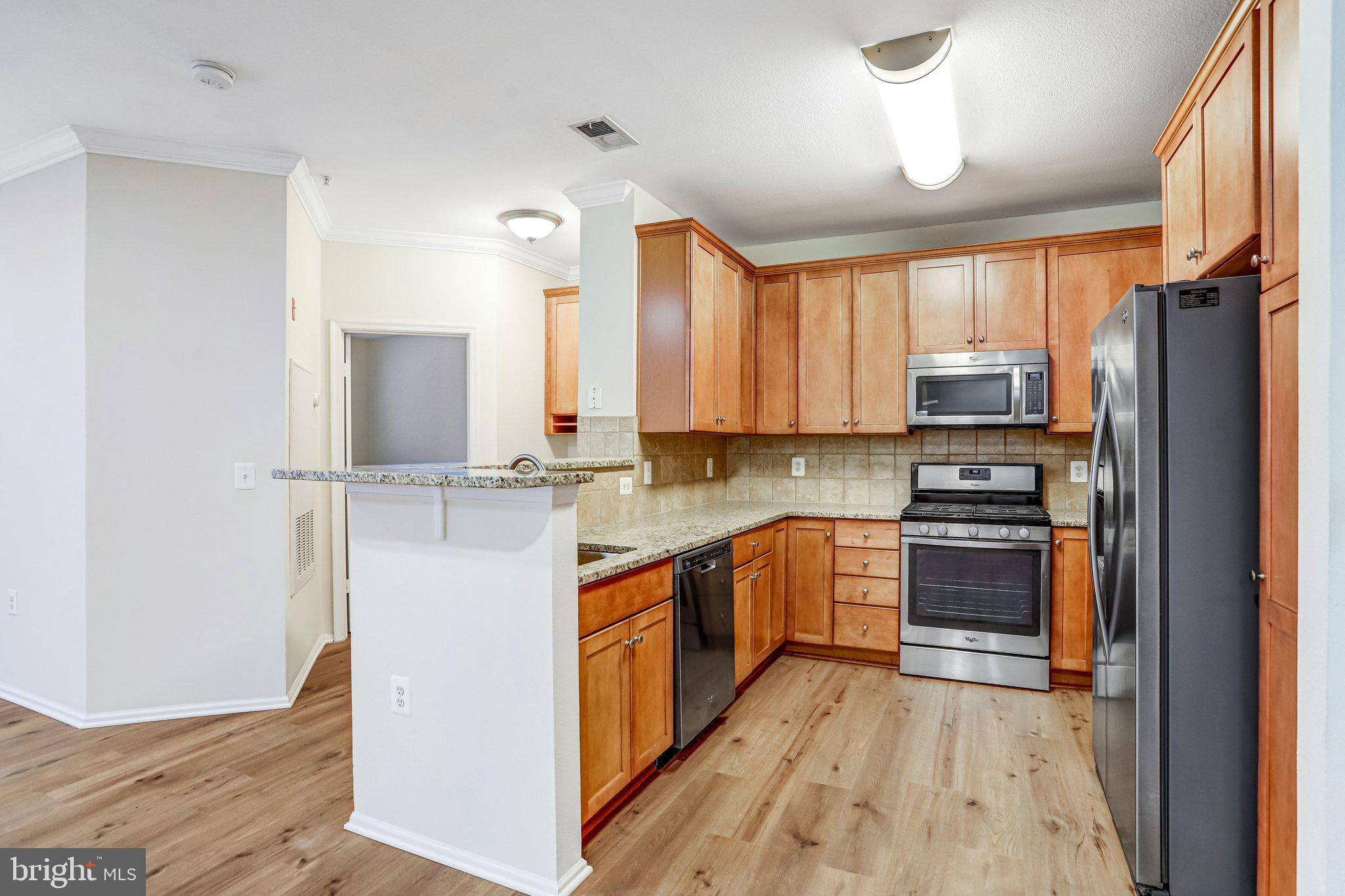 11800 Old Georgetown Road, Unit 1207 North Bethesda, MD 20852 - Photo 22 of 65 a kitchen with stainless steel appliances granite countertop a refrigerator stove and sink