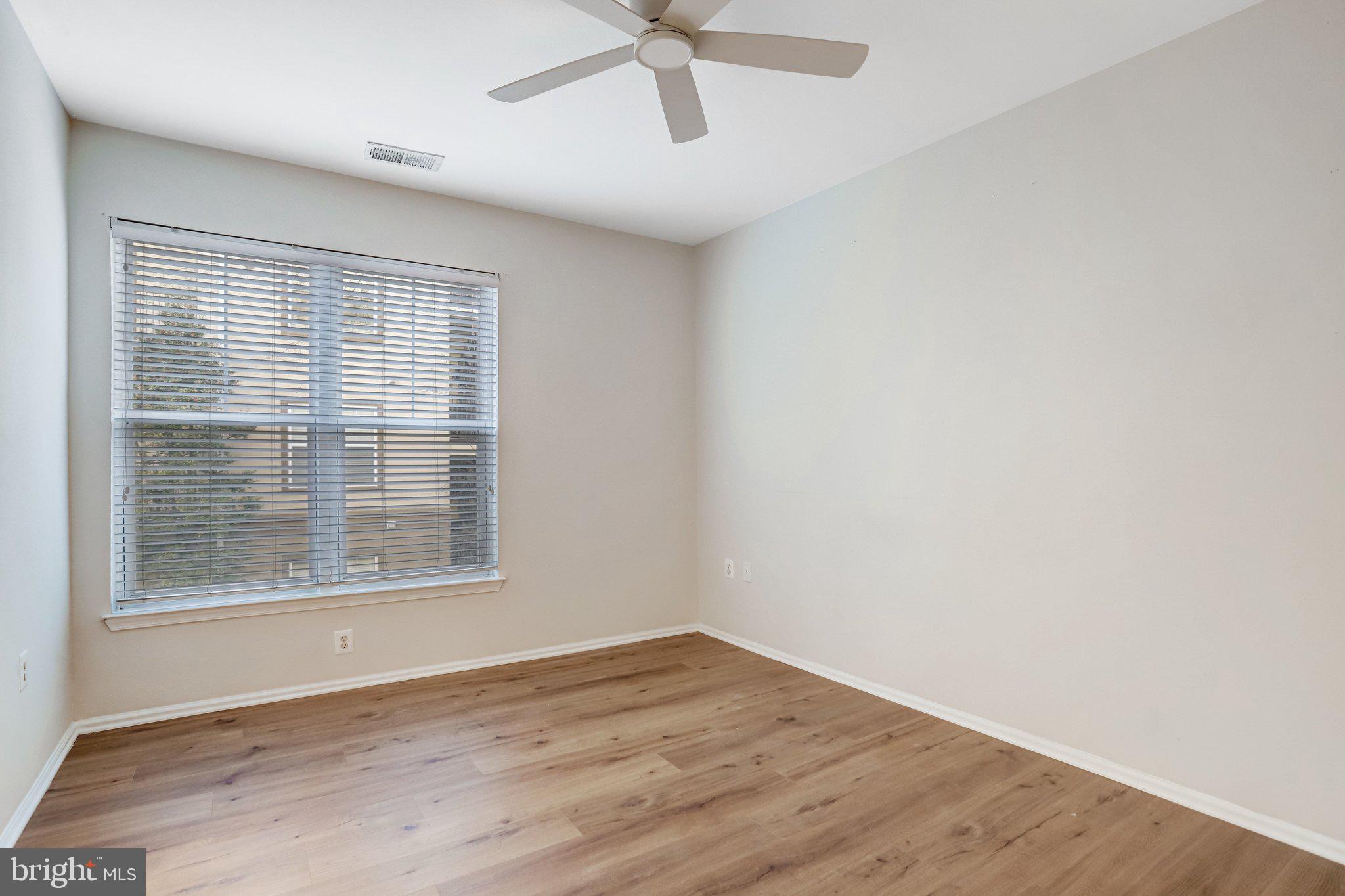 11800 Old Georgetown Road, Unit 1207 North Bethesda, MD 20852 - Photo 26 of 65 a view of empty room with wooden floor and fan