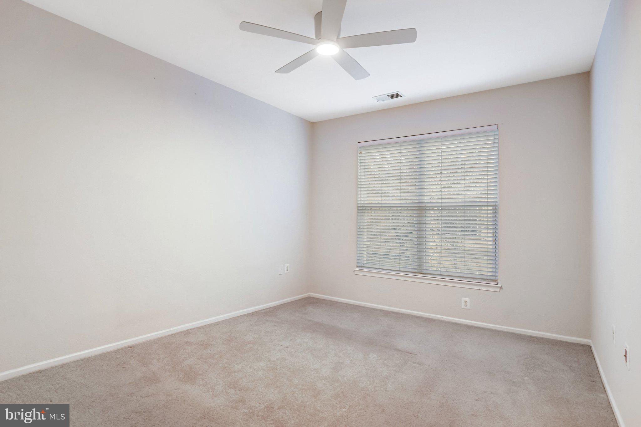 11800 Old Georgetown Road, Unit 1207 North Bethesda, MD 20852 - Photo 34 of 65 an empty room with chandelier fan and windows