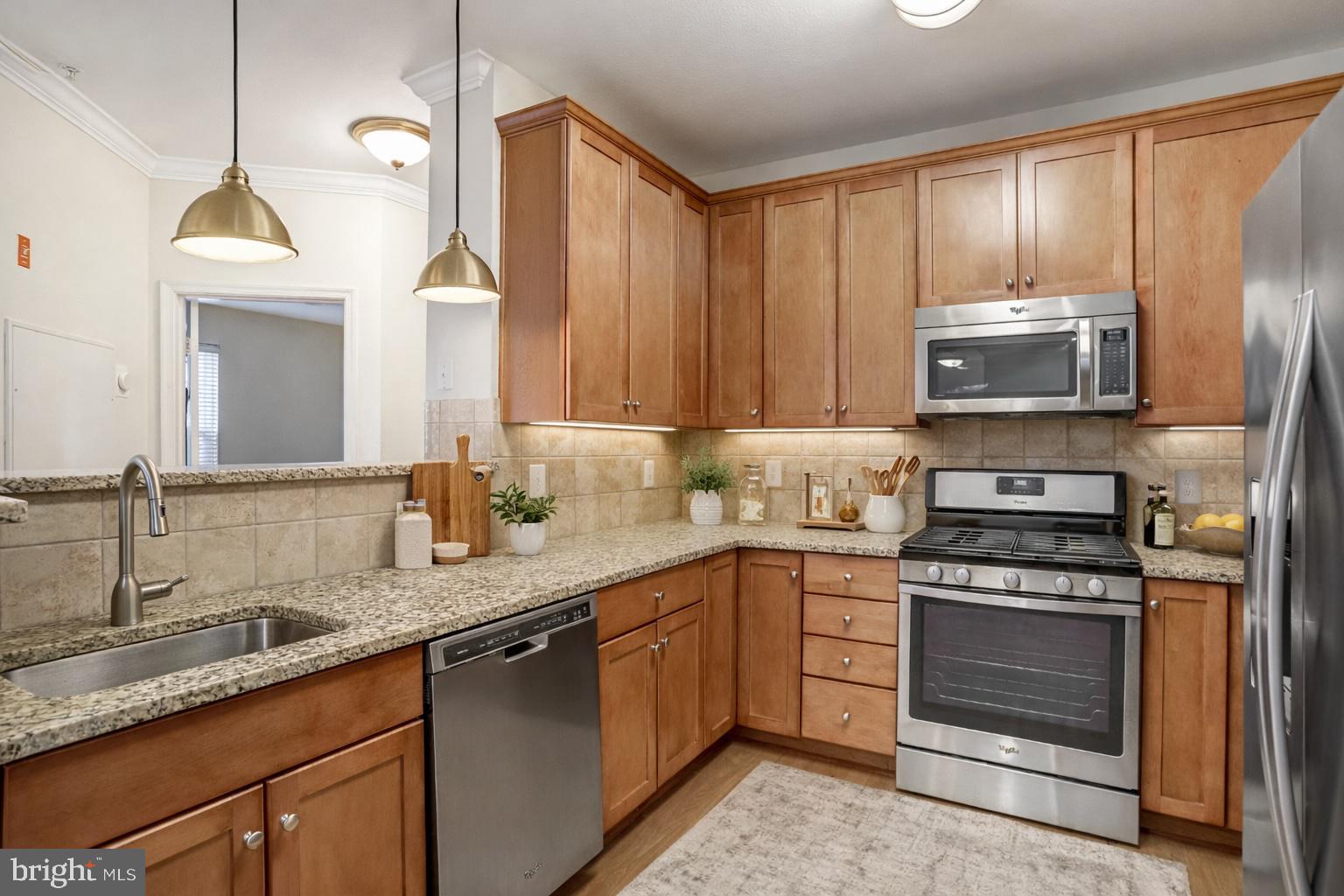 11800 Old Georgetown Road, Unit 1207 North Bethesda, MD 20852 - Photo 5 of 65 a kitchen with stainless steel appliances granite countertop a stove a sink and a microwave