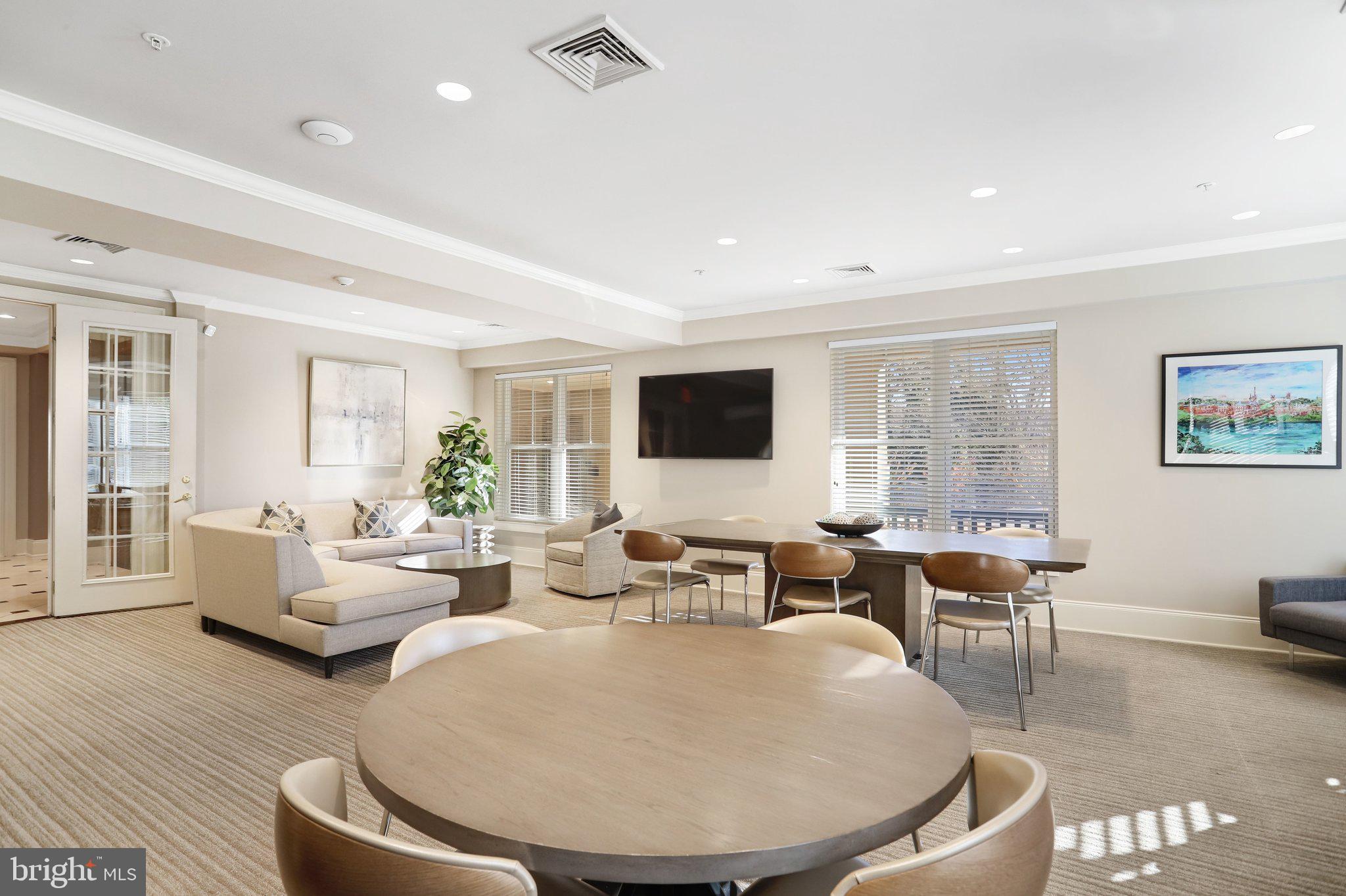 11800 Old Georgetown Road, Unit 1207 North Bethesda, MD 20852 - Photo 53 of 65 a living room with couches and a dining table with wooden floor