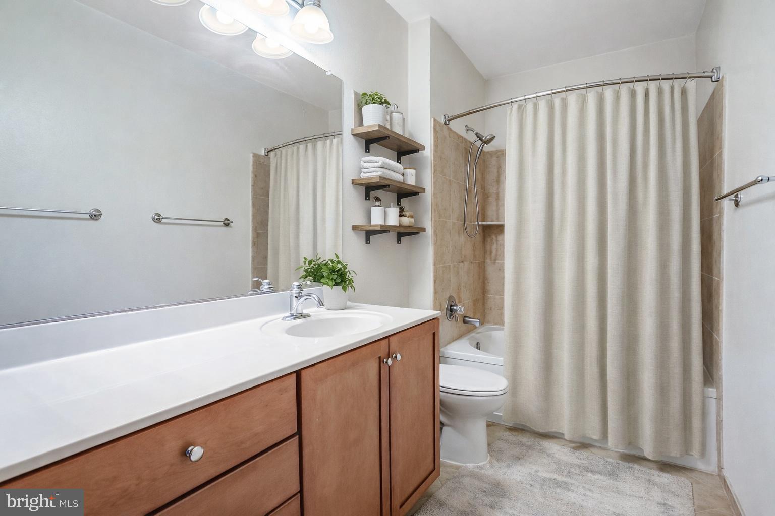 11800 Old Georgetown Road, Unit 1207 North Bethesda, MD 20852 - Photo 8 of 65 a bathroom with a granite countertop sink and a mirror