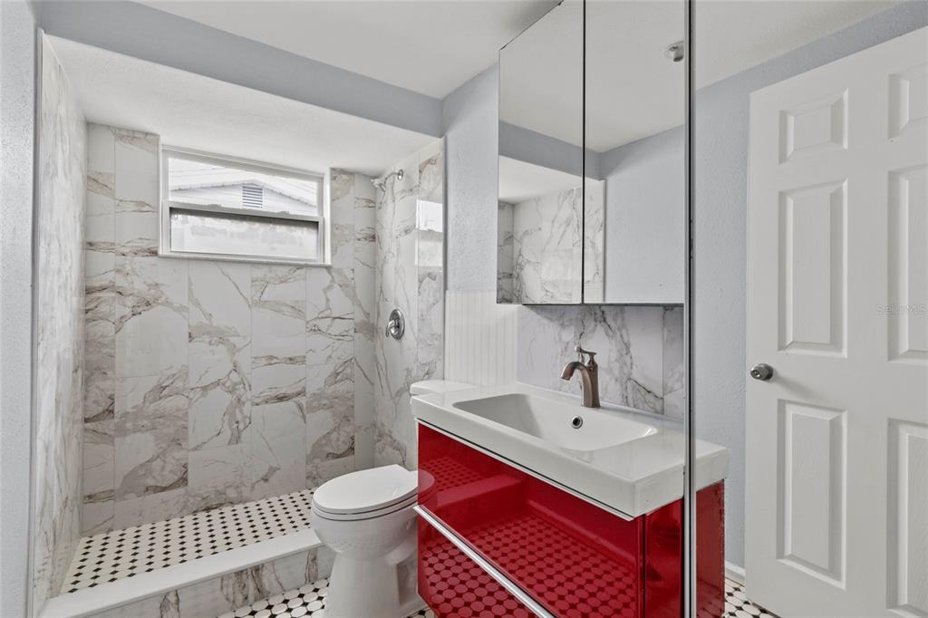 1623 Plum Tree Road Holiday, FL 34690 - Photo 17 of 33 a bathroom with a sink toilet a mirror and shower