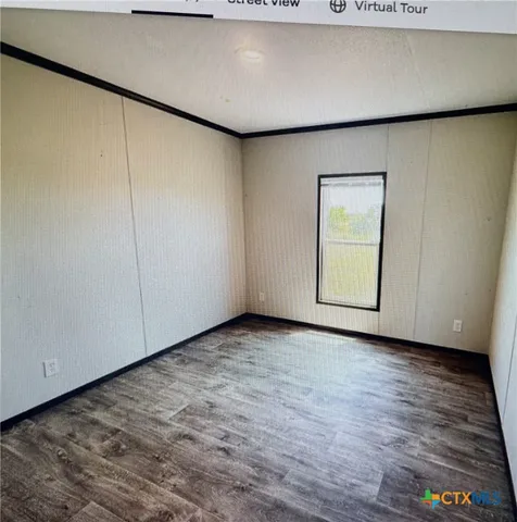 a view of an empty room with closet