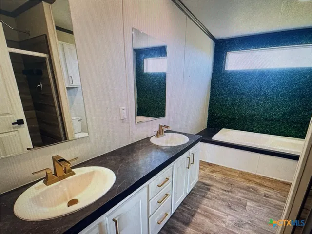 a bathroom with a double vanity sink and a mirror