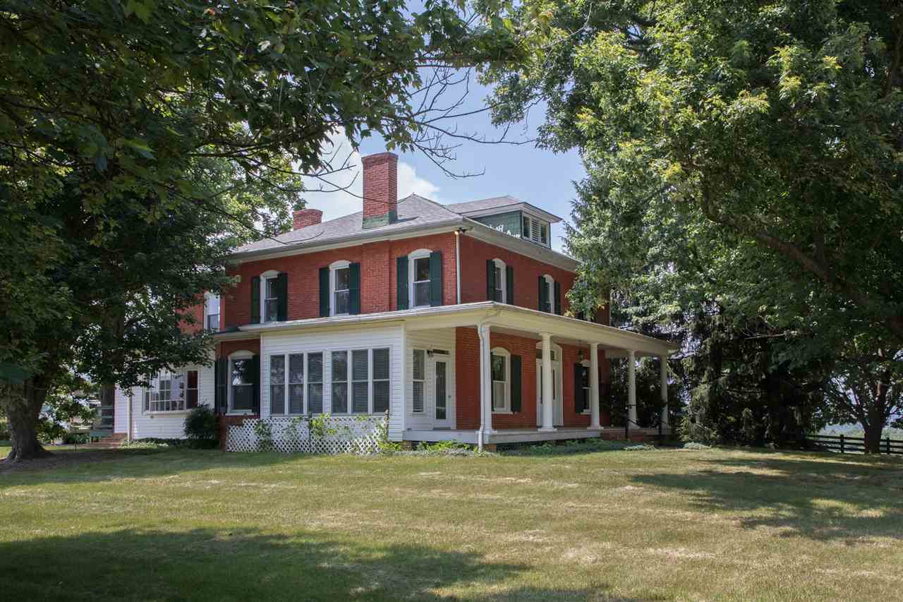 395 Kindig Road Waynesboro, VA 22980 - Photo 1 of 45 a view of a brick house with a yard lawn chairs and a large tree