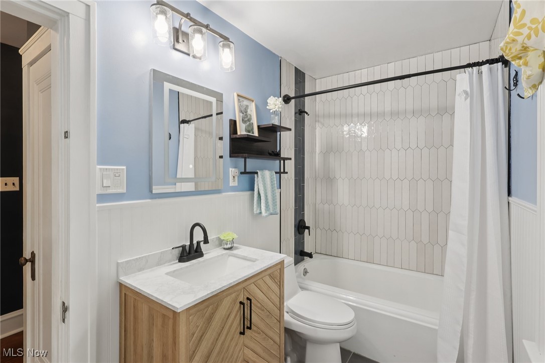 2482 Princeton Road Cleveland, OH 44118 - Photo 16 of 32 Full bath with shower / bath combination with curtain, a wainscoted wall, and vanity