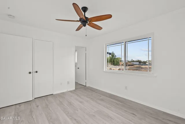 a view of a livingroom with a ceiling fan and window