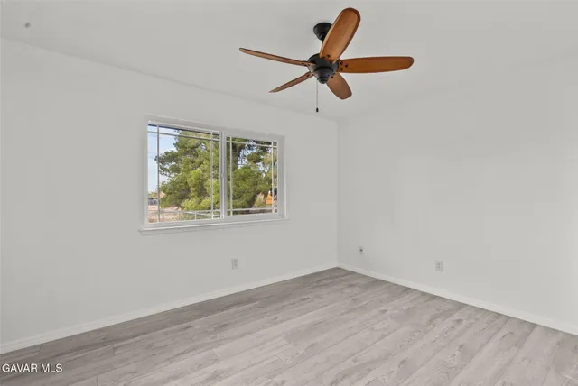 a view of a room with a window and a ceiling fan