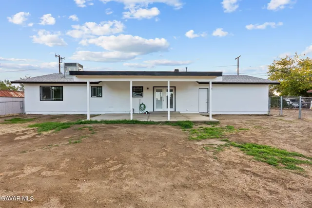 a view of a yard and car parked