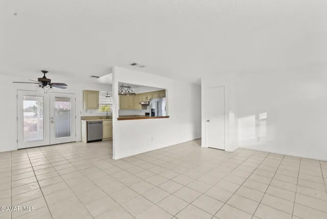 a view of a kitchen with furniture and an empty room