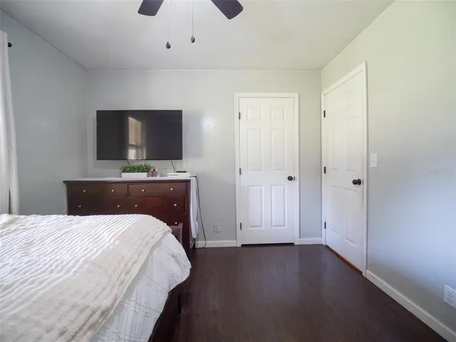 a bedroom with a bed and a flat screen tv