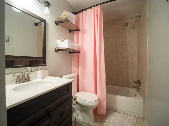 a bathroom with a sink toilet and mirror