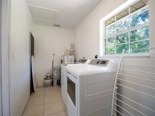 a view of an outdoor space with a chair and potted plant