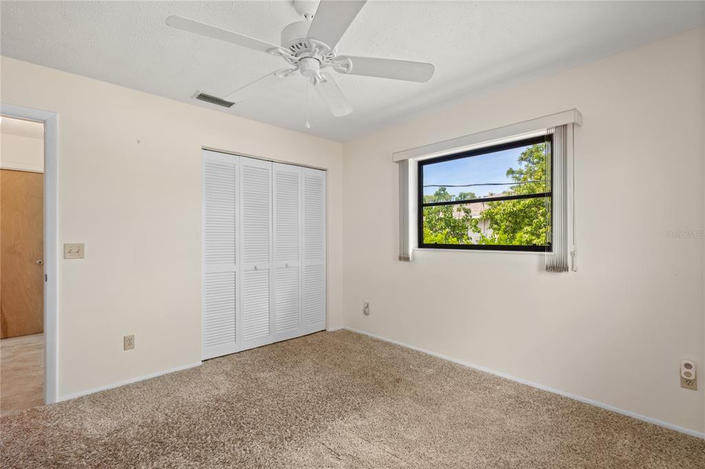 420 Duke Road Venice, FL 34293 - Photo 15 of 22 an empty room with a ceiling fan and a window