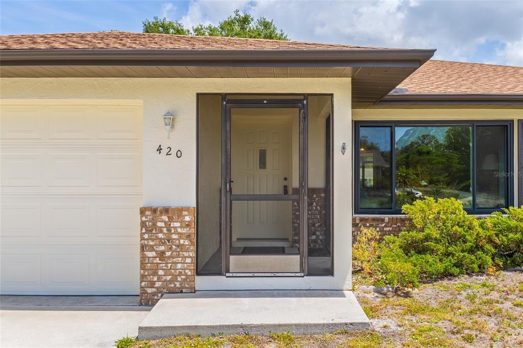 420 Duke Road Venice, FL 34293 - Photo 4 of 22 a front view of a house with a yard