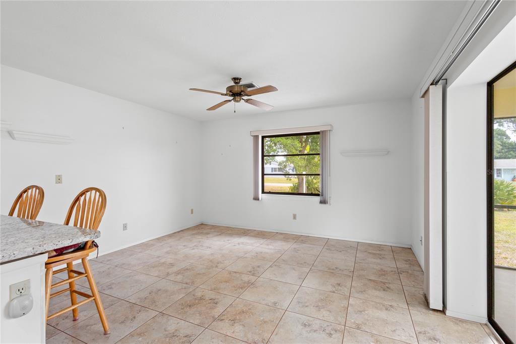 420 Duke Road Venice, FL 34293 - Photo 8 of 22 a view of a livingroom with a piano and wooden floor