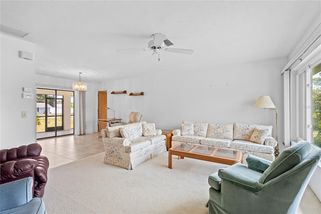 420 Duke Road Venice, FL 34293 - Photo 10 of 22 a living room with furniture and a chandelier