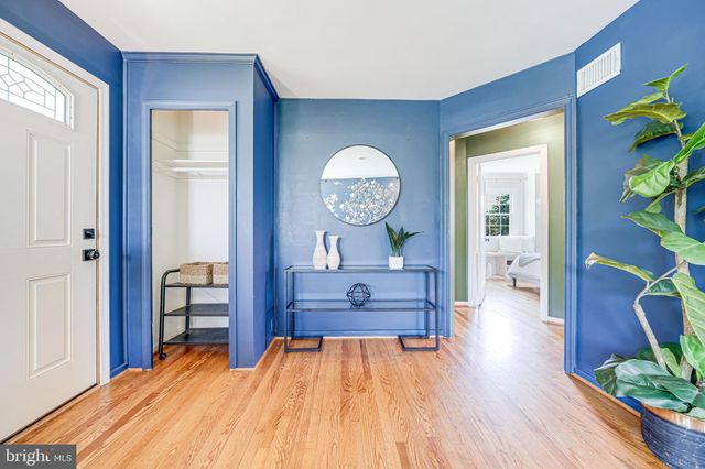 a room with wooden floor and furniture