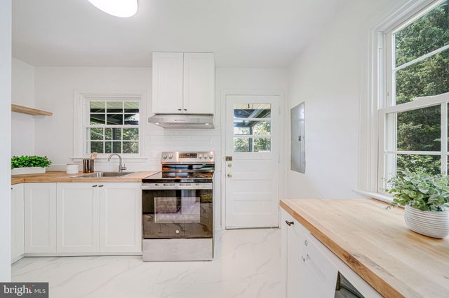 a kitchen with granite countertop a stove and a sink