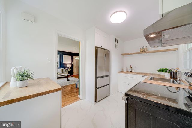 a kitchen with a sink and refrigerator