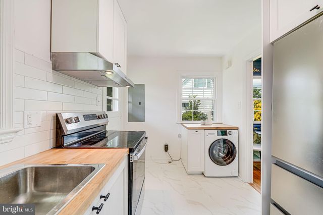 a kitchen with a stove and a white refrigerator