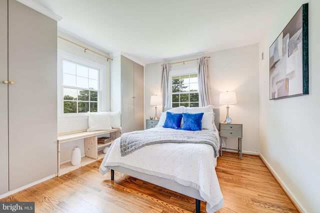 a bedroom with a bed and a table in it with window