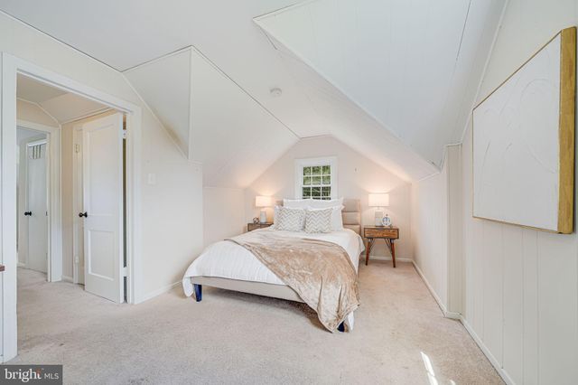 a bedroom with a bed and a night stand