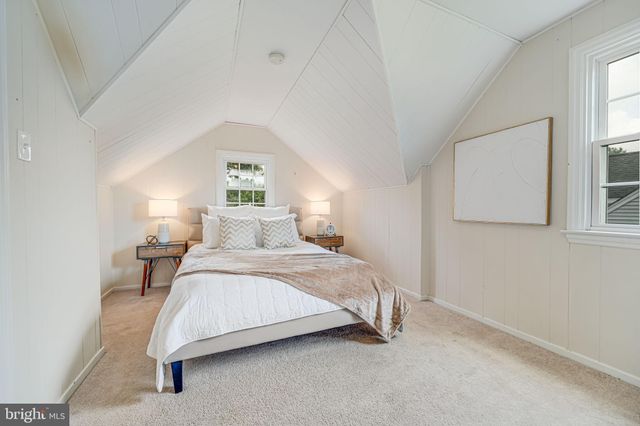 a bedroom with a bed and a night stand