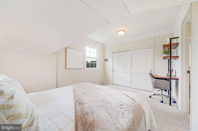 a bedroom with a bed and a large mirror