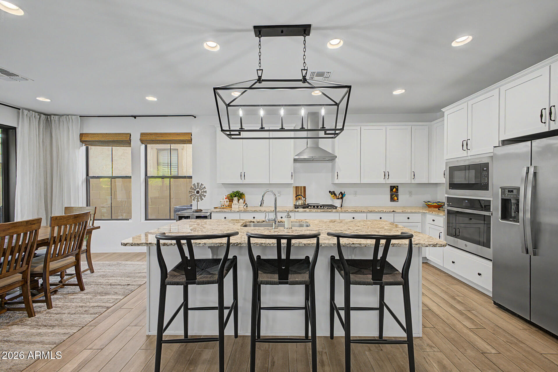 819 West Deer Creek Road Phoenix, AZ 85048 - Photo 29 of 76 a kitchen with stainless steel appliances a dining table chairs and stove