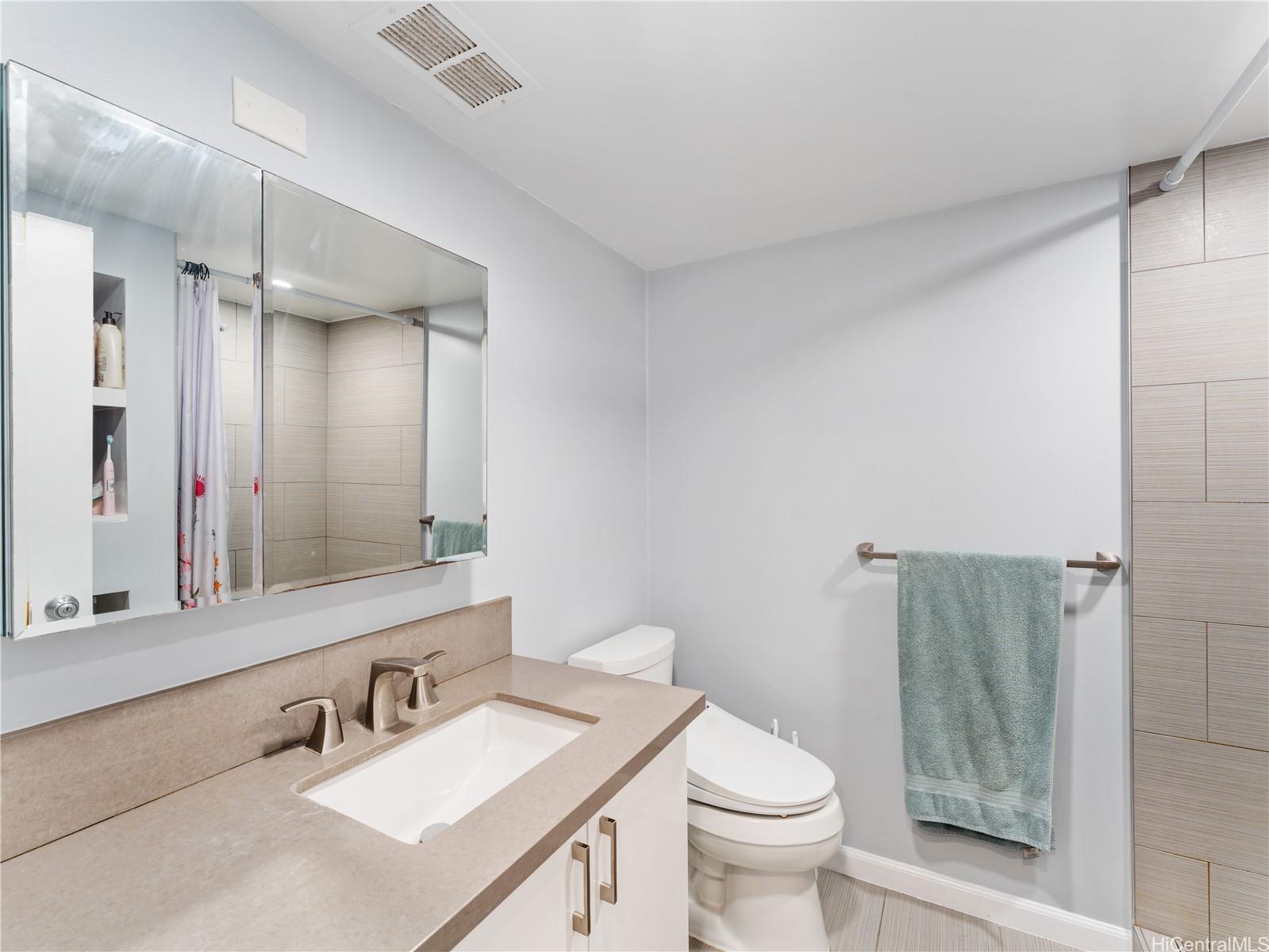 4300 Waialae Avenue, Unit B601 Honolulu, HI 96816 - Photo 9 of 18 a bathroom with a sink toilet and shower