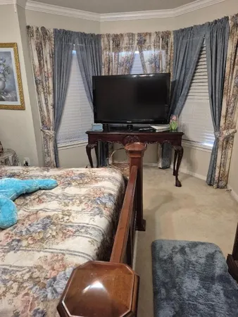 a bedroom with furniture and a chandelier
