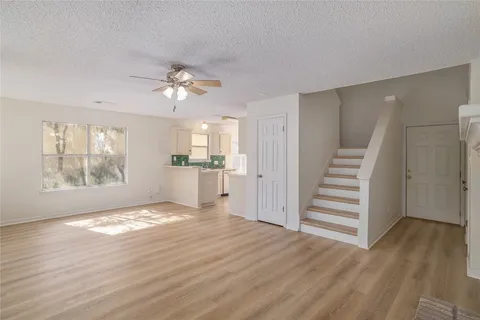 a view of a kitchen with wooden floor and a kitchen space