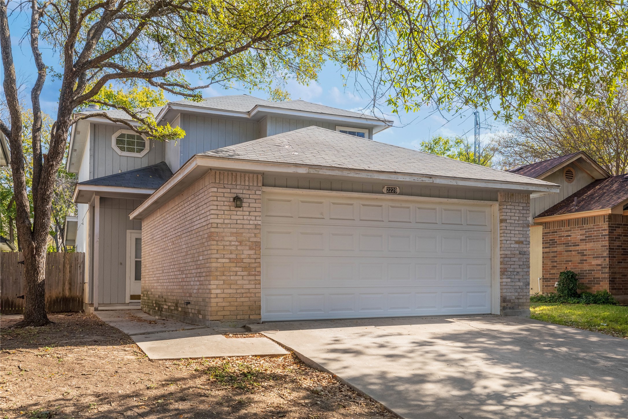 2229 Jasmine Path Round Rock, TX 78664 - Photo 21 of 28 View of front of home featuring brick siding, concrete driveway, a shingled roof, and an attached garage