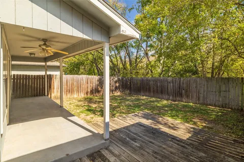 a view of a backyard with a small cabin and wooden fence