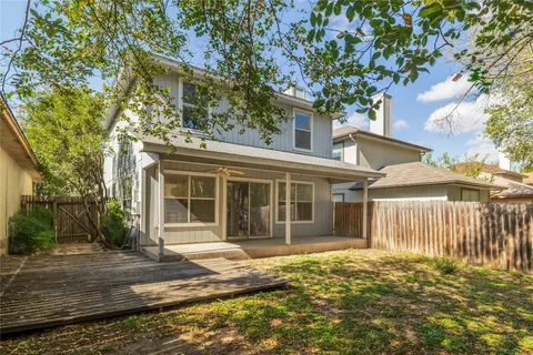 a view of a yard of a house with a tree