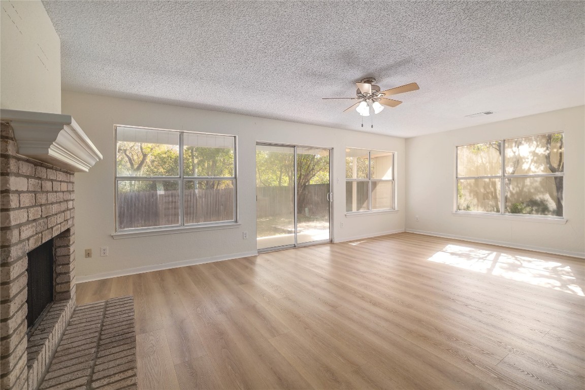 2229 Jasmine Path Round Rock, TX 78664 - Photo 4 of 28 a view of an empty room with a window and wooden floor