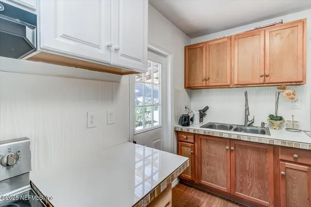a kitchen with stainless steel appliances granite countertop a sink stove and cabinets