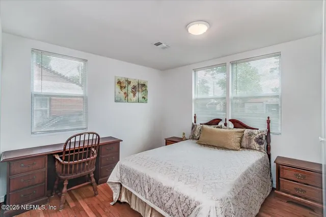 a bedroom with a bed chair and a window