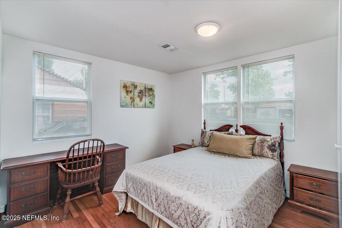 4636 Timuquana Road Jacksonville, FL 32210 - Photo 17 of 21 a bedroom with a bed chair and a window