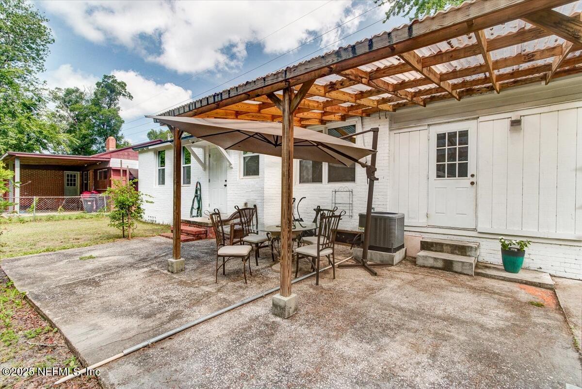 4636 Timuquana Road Jacksonville, FL 32210 - Photo 21 of 21 a view of patio with a table and chairs under an umbrella
