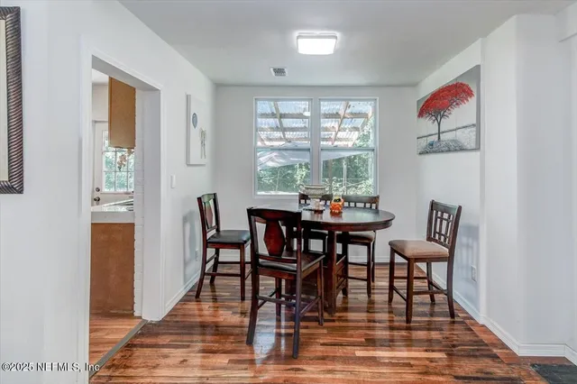 a dining room with furniture window wooden floor