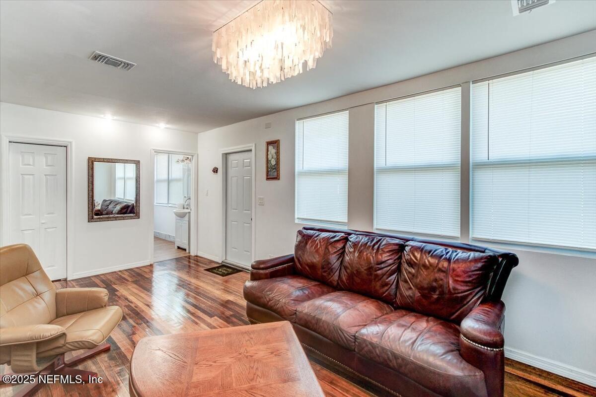 4636 Timuquana Road Jacksonville, FL 32210 - Photo 7 of 21 a living room with furniture and a chandelier