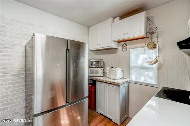 a kitchen with stainless steel appliances granite countertop a refrigerator and a stove