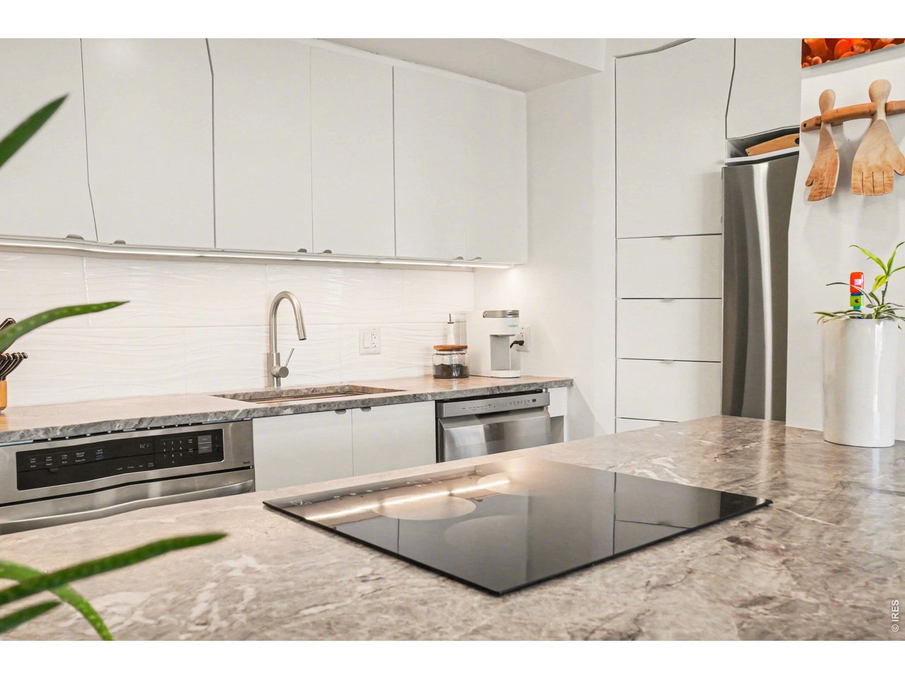1020 15th Street, Unit 32L Denver, CO 80202 - Photo 15 of 32 a kitchen with stainless steel appliances granite countertop a sink stove and refrigerator