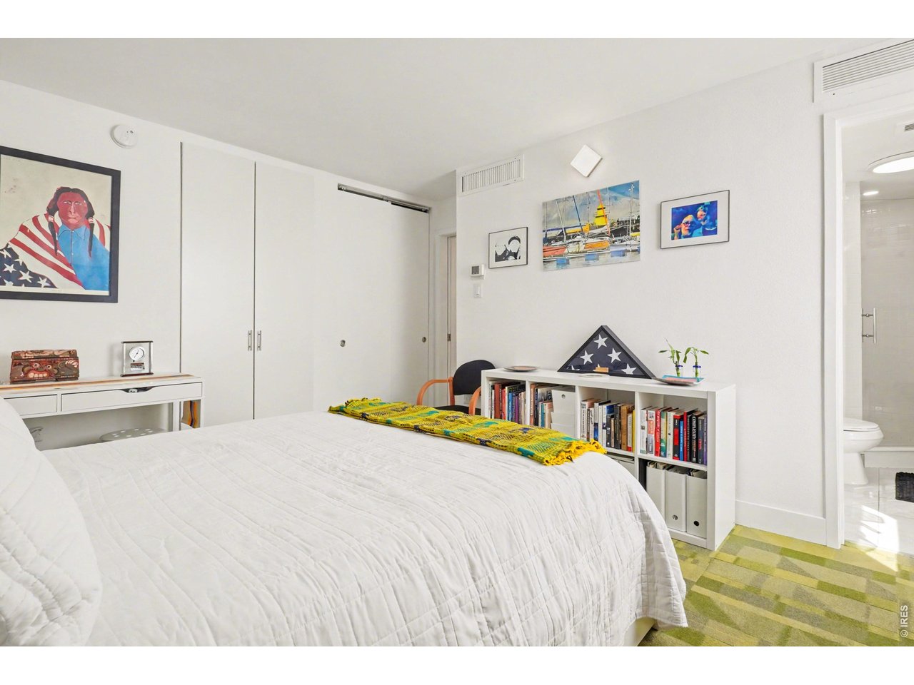 1020 15th Street, Unit 32L Denver, CO 80202 - Photo 18 of 32 a bedroom with a bed a wall painting and a book shelf