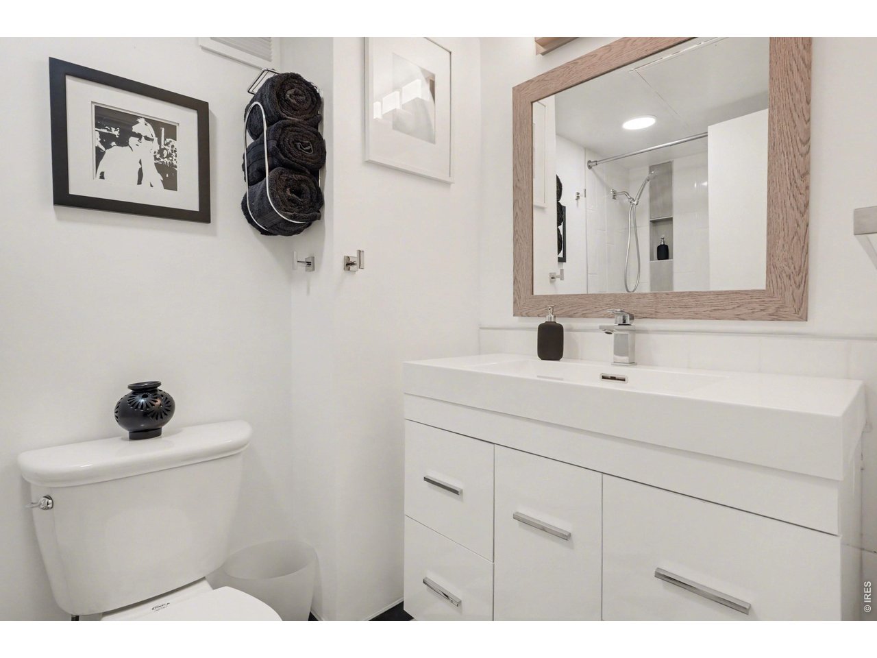 1020 15th Street, Unit 32L Denver, CO 80202 - Photo 25 of 32 a bathroom with a sink mirror and toilet