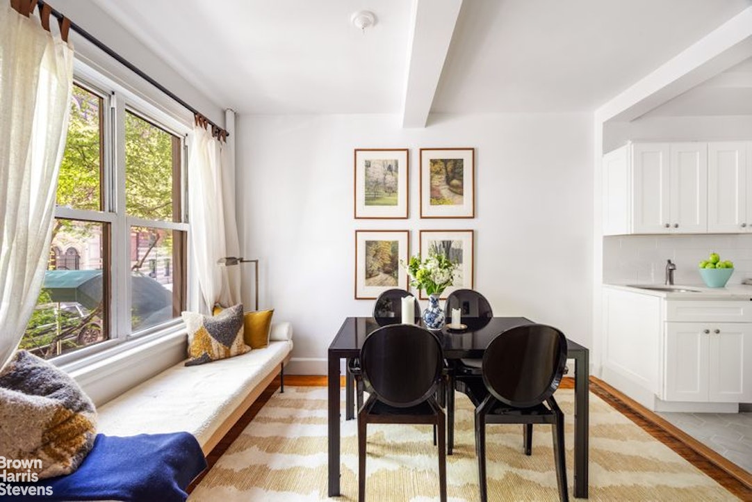 12 East 97th Street, Unit 2G Manhattan, NY 10128 - Photo 2 of 7 a dining room with furniture and a large window