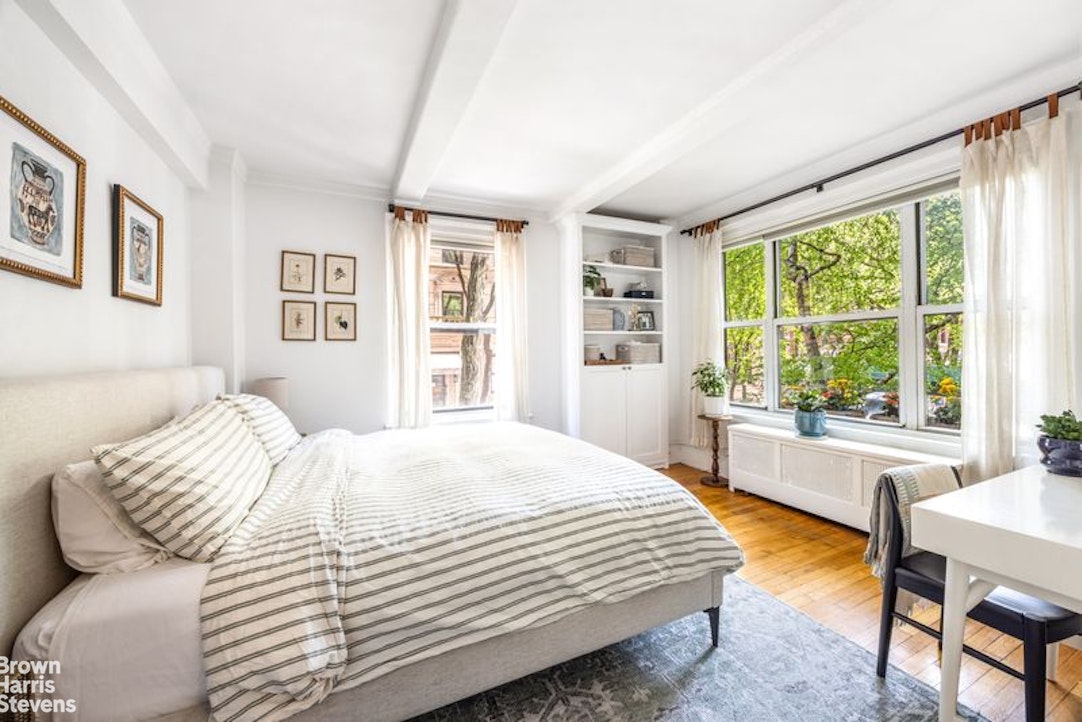 12 East 97th Street, Unit 2G Manhattan, NY 10128 - Photo 4 of 7 a bedroom with a bed and a large window